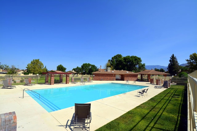 view of swimming pool featuring a pergola and a patio area