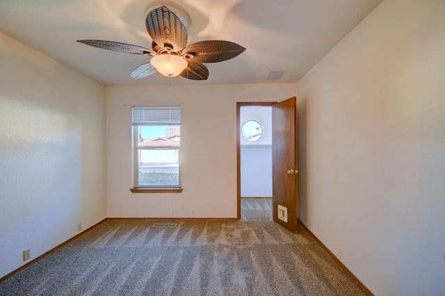 empty room featuring ceiling fan and carpet floors