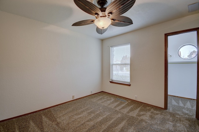 spare room with ceiling fan and carpet flooring