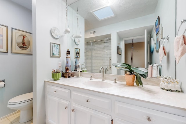 bathroom featuring walk in shower, toilet, a textured ceiling, vanity, and tile patterned flooring