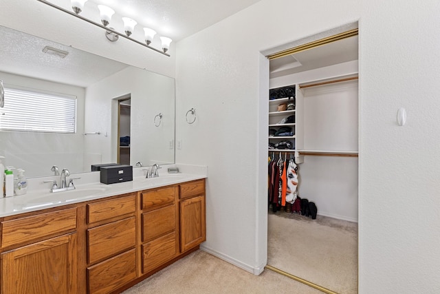 bathroom with vanity and a textured ceiling