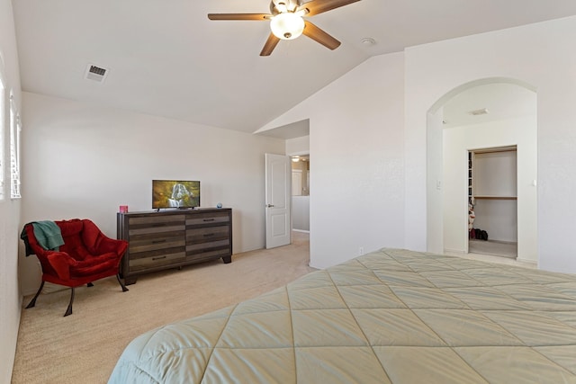 bedroom featuring ceiling fan, vaulted ceiling, and light carpet