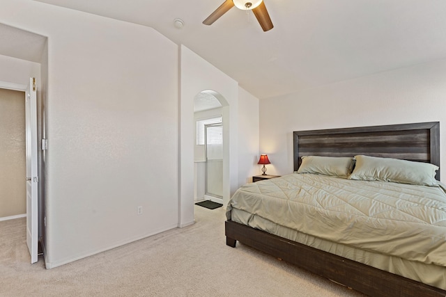 bedroom featuring ceiling fan, vaulted ceiling, and light carpet