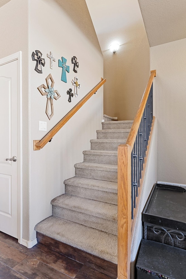 stairway with hardwood / wood-style flooring