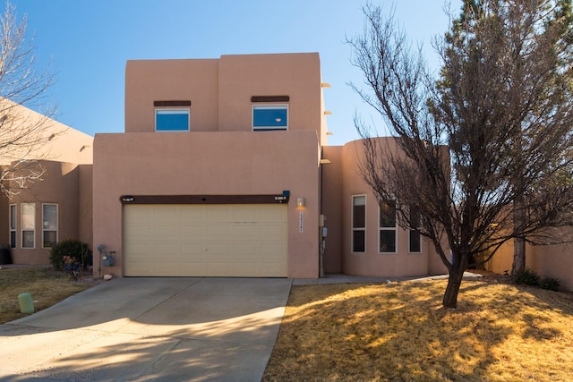 pueblo-style home featuring a garage