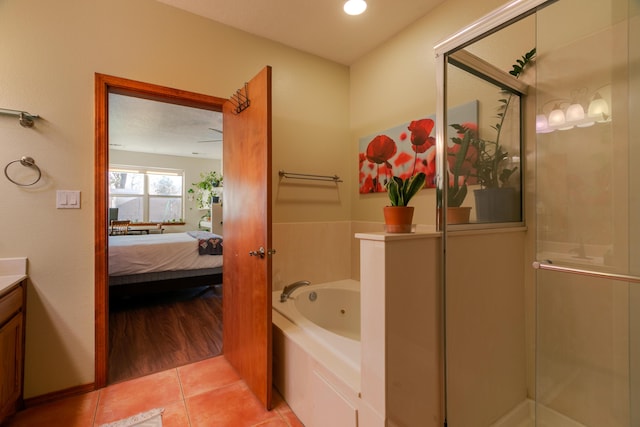 bathroom with independent shower and bath, vanity, and tile patterned flooring