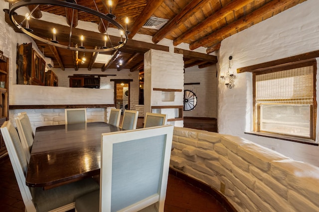 dining space featuring beamed ceiling and wooden ceiling