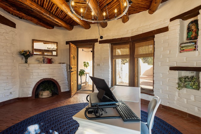 home office with beam ceiling, a brick fireplace, and wood ceiling