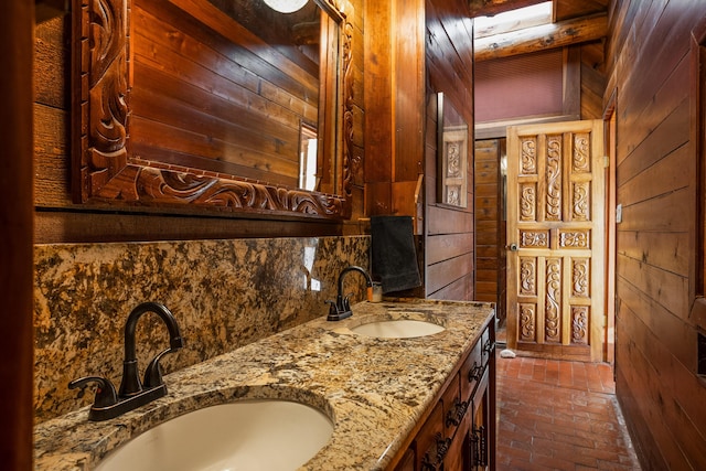 bathroom featuring vanity and wooden walls