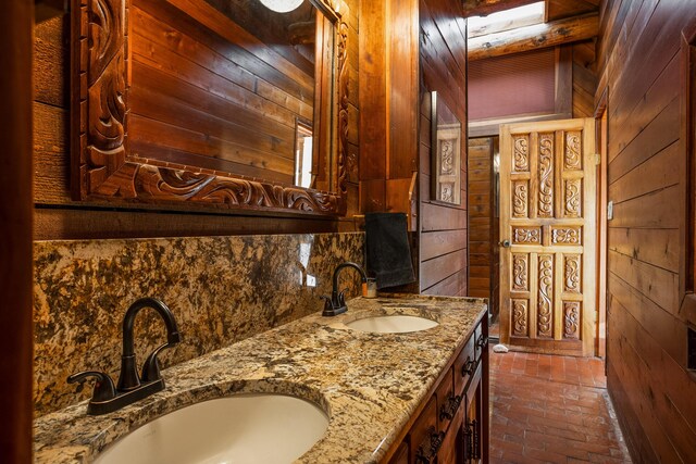 bathroom featuring vanity and wooden walls