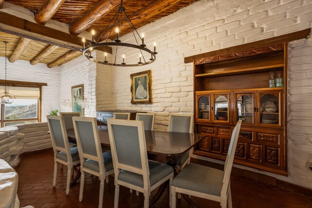 dining room featuring beam ceiling, brick wall, wood ceiling, and a chandelier