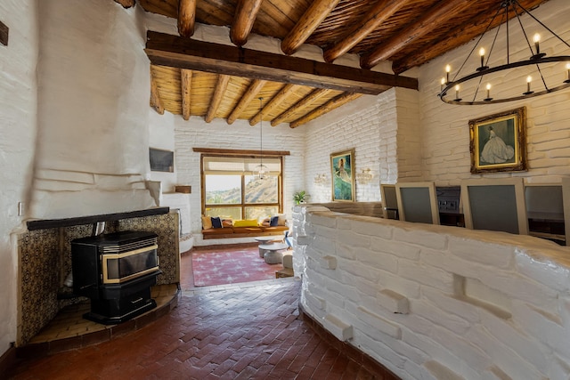 living room featuring an inviting chandelier, wooden ceiling, beamed ceiling, and a wood stove