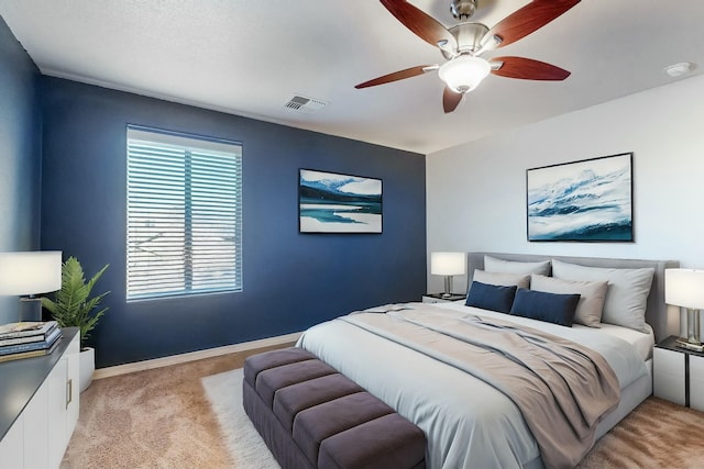 bedroom featuring ceiling fan and light carpet