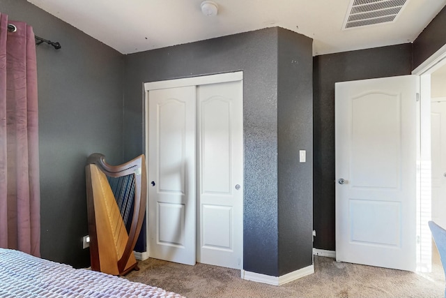 carpeted bedroom featuring a closet