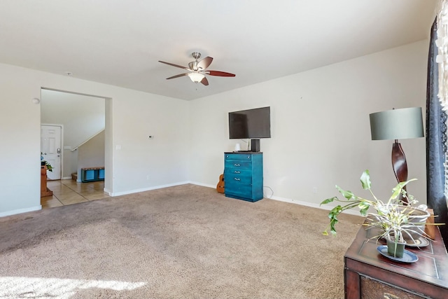 unfurnished living room featuring light colored carpet and ceiling fan