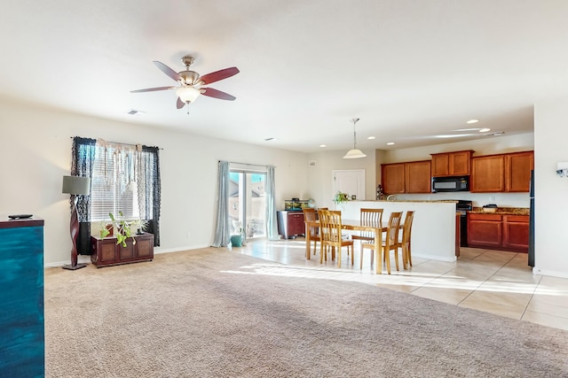 unfurnished living room featuring ceiling fan and light carpet