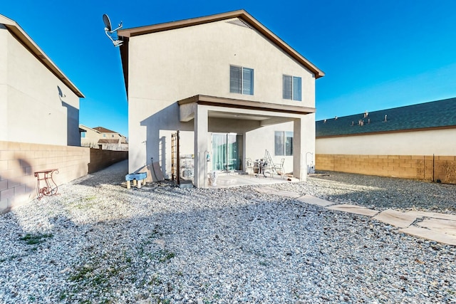 rear view of property featuring a patio area