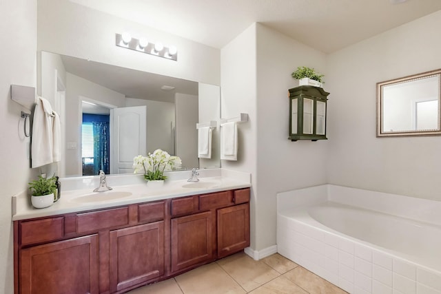 bathroom featuring tile patterned flooring, vanity, and a tub