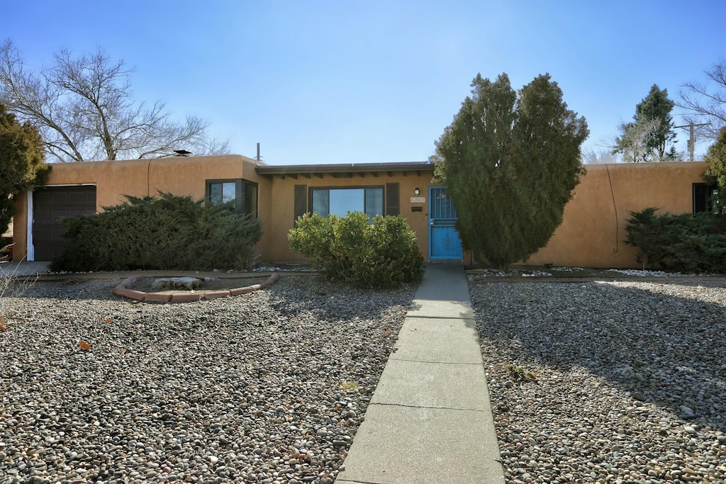 pueblo-style house with a garage