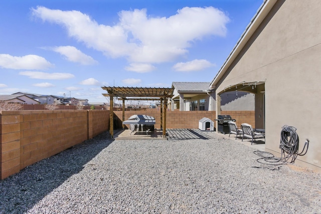 view of yard featuring a patio area, a pergola, and a fenced backyard