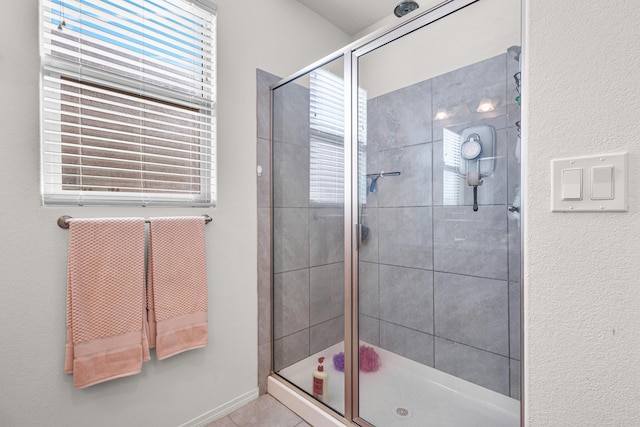 bathroom featuring tile patterned flooring and an enclosed shower