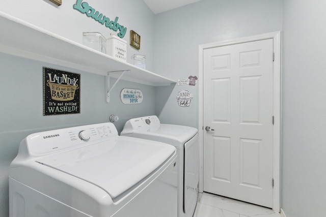 washroom featuring marble finish floor, washing machine and dryer, and laundry area