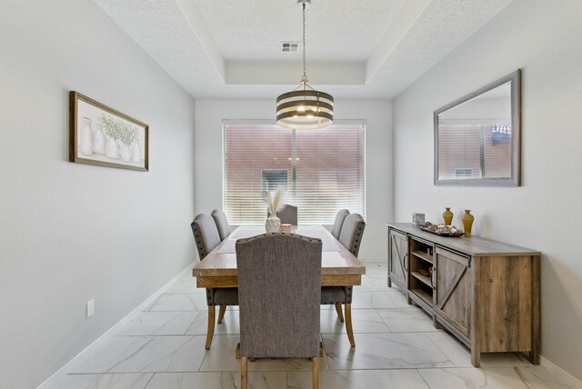 dining room featuring ceiling fan with notable chandelier and a textured ceiling