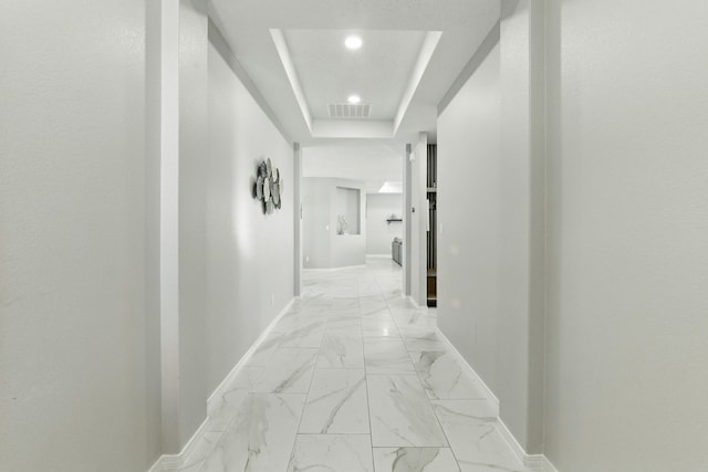 hall featuring recessed lighting, visible vents, baseboards, and marble finish floor