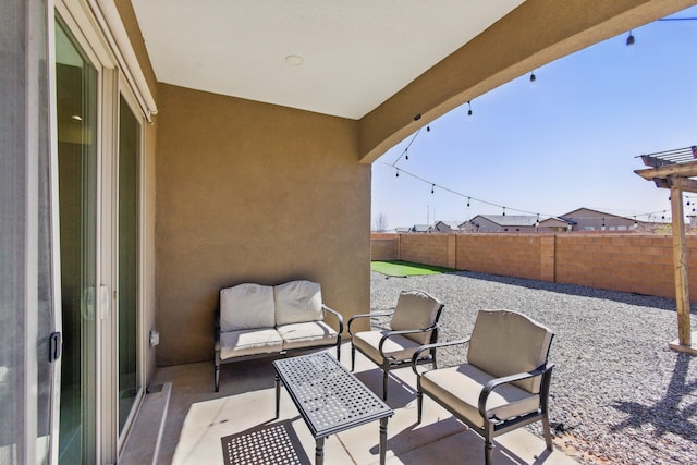 view of patio with outdoor lounge area and fence