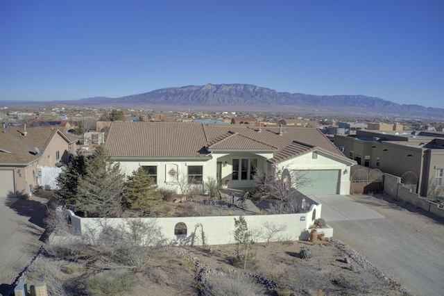 view of front of house with a garage and a mountain view