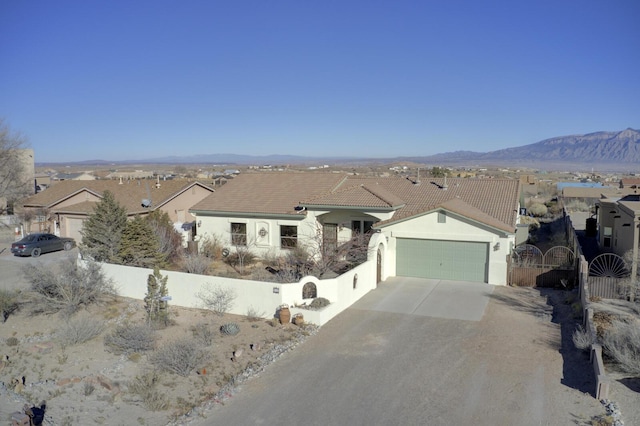 ranch-style home with a mountain view and a garage