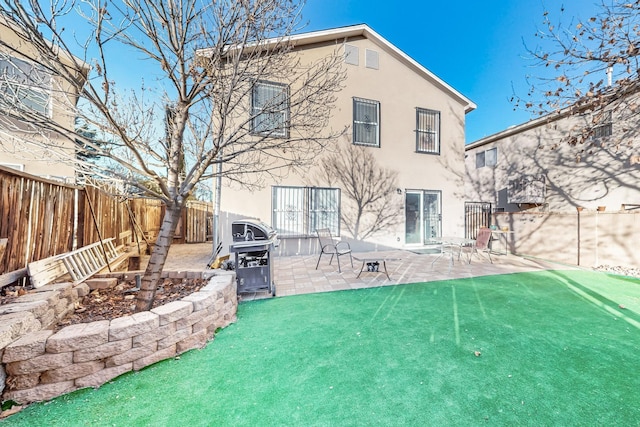 back of house featuring a yard and a patio area