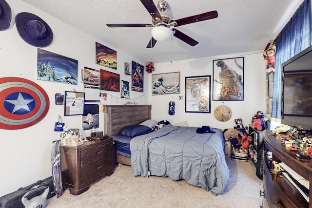 carpeted bedroom featuring ceiling fan and a textured ceiling