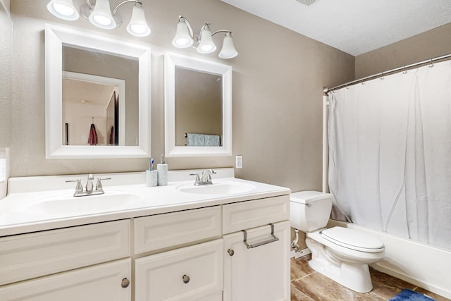 full bathroom featuring vanity, shower / tub combo, and toilet