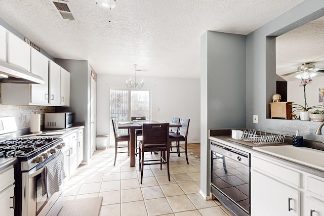 kitchen featuring light tile patterned flooring, white cabinetry, tasteful backsplash, decorative light fixtures, and appliances with stainless steel finishes