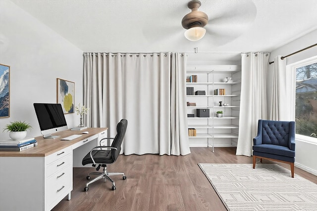 office with ceiling fan, a textured ceiling, and light wood-type flooring