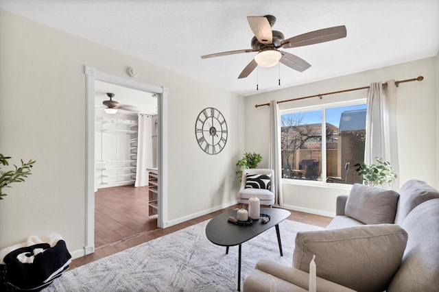 living area featuring hardwood / wood-style floors and ceiling fan