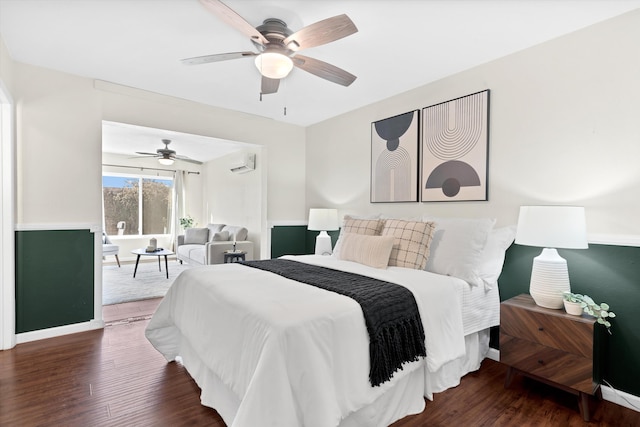 bedroom featuring a wall mounted air conditioner, dark hardwood / wood-style floors, ceiling fan, and access to exterior