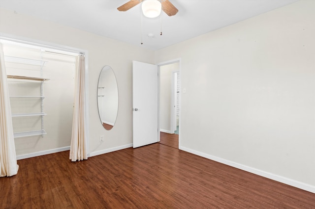 unfurnished bedroom with ceiling fan and dark hardwood / wood-style flooring