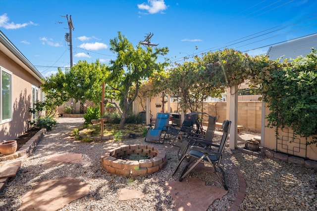 view of yard with a fire pit