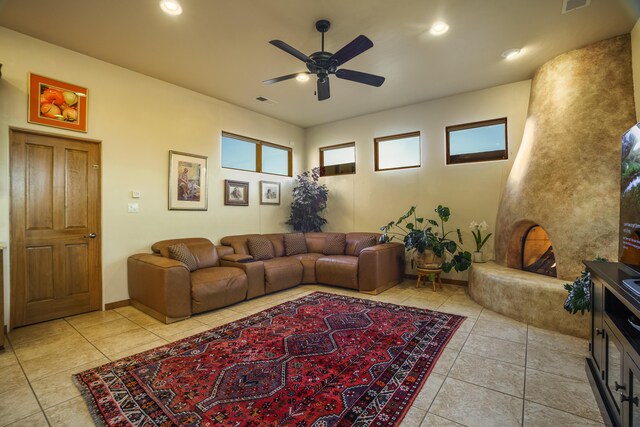 bedroom featuring multiple windows, light colored carpet, a fireplace, and ceiling fan