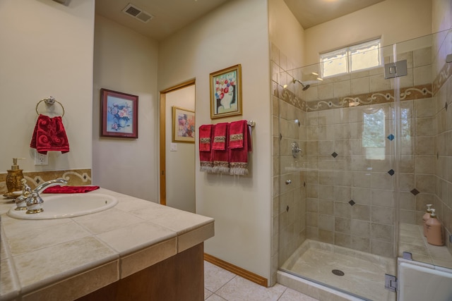 bathroom featuring vanity, an enclosed shower, and tile patterned floors