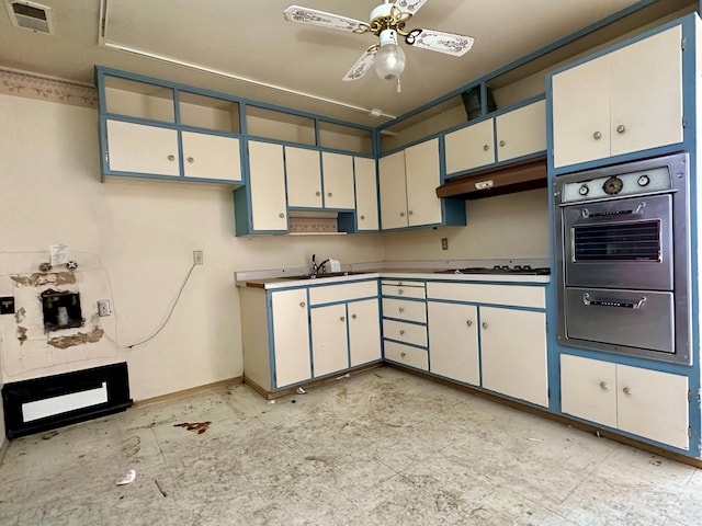 kitchen featuring sink, gas cooktop, ceiling fan, white cabinetry, and stainless steel oven