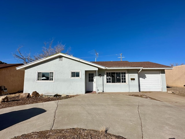 rear view of property featuring a garage