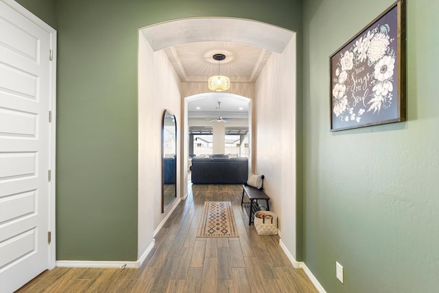 corridor featuring hardwood / wood-style flooring and crown molding