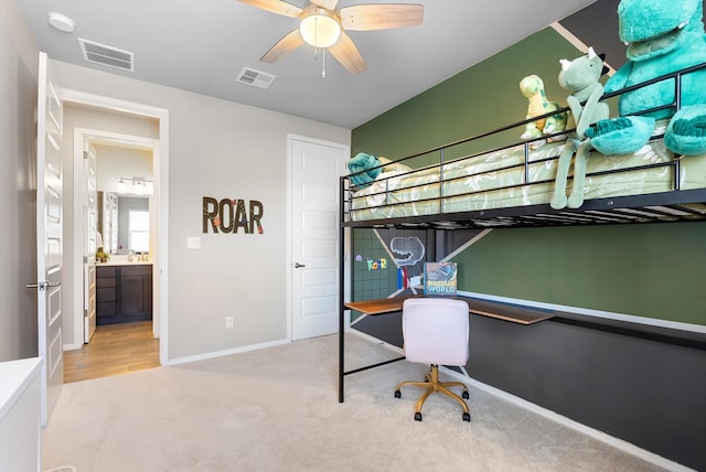 bedroom with sink, light colored carpet, and ceiling fan