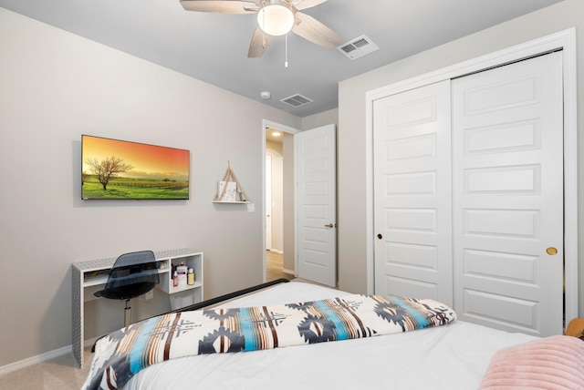 carpeted bedroom with ceiling fan and a closet