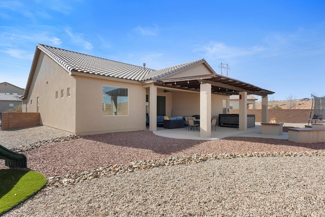 back of property featuring an outdoor living space and a patio