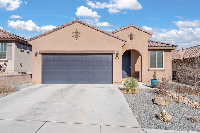 mediterranean / spanish-style home with a garage