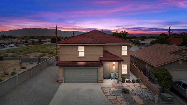 view of front facade featuring a garage and a mountain view